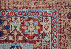 A close-up of a handmade Afghan Balkh rug featuring a detailed Mamluk medallion pattern.