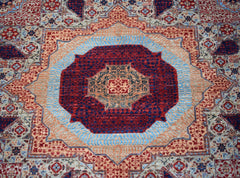 Handwoven Afghan Balkh rug featuring a detailed Mamluk medallion in red, blue, and tan wool.