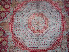 Handwoven Afghan Balkh rug featuring a detailed red Mamluk medallion on a light blue field.