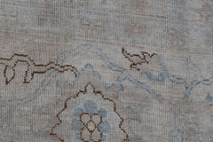 A close-up of a handwoven Afghan rug featuring a detailed brown and blue Mamluk pattern.