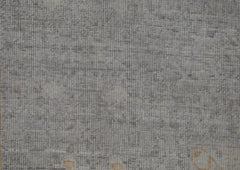 A handwoven Afghan Balkh rug featuring a textured, neutral grey wool pile with subtle variations.