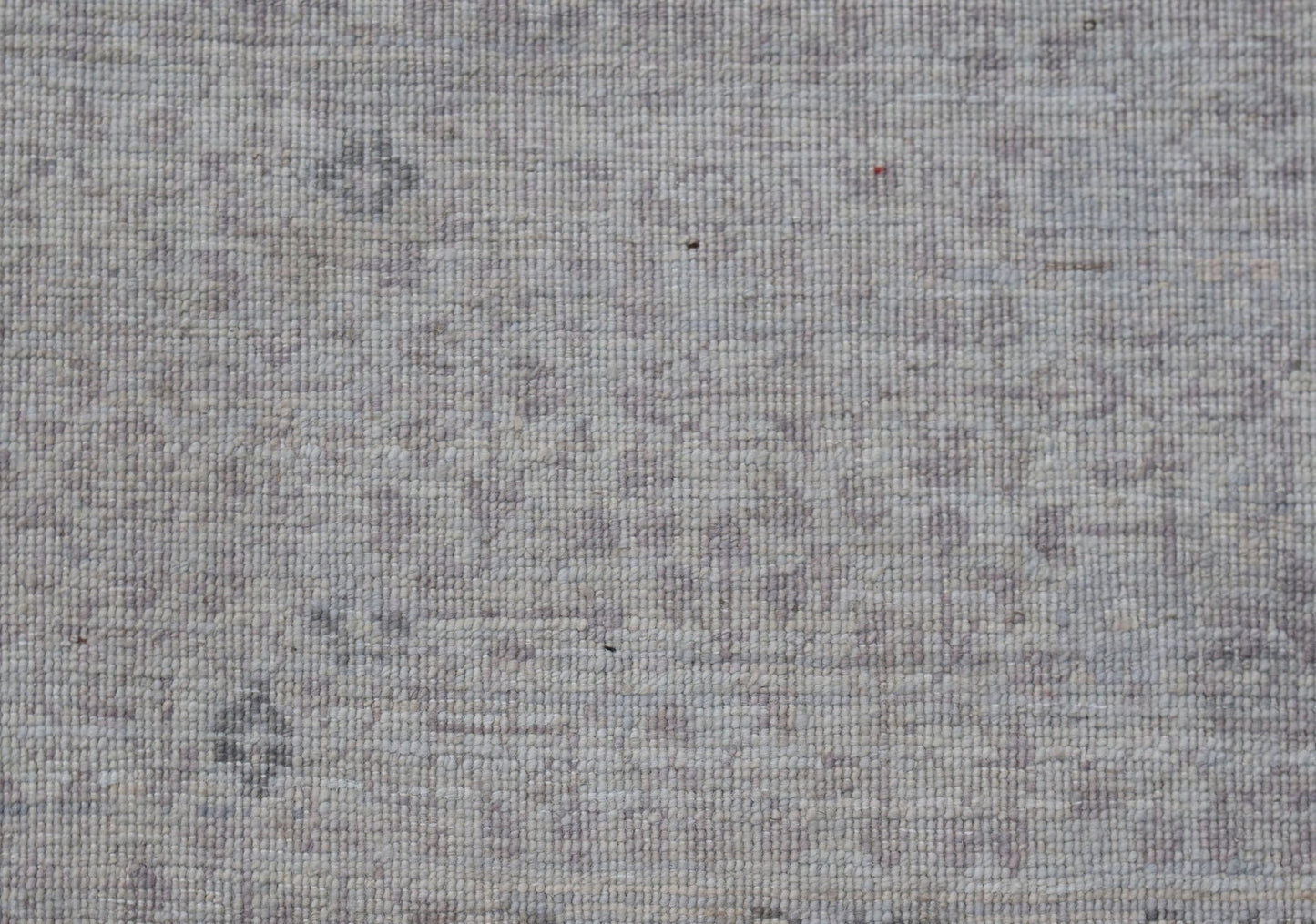 A close-up of a handwoven Afghan Balkh rug featuring a subtle, light-toned Mamluk pattern.