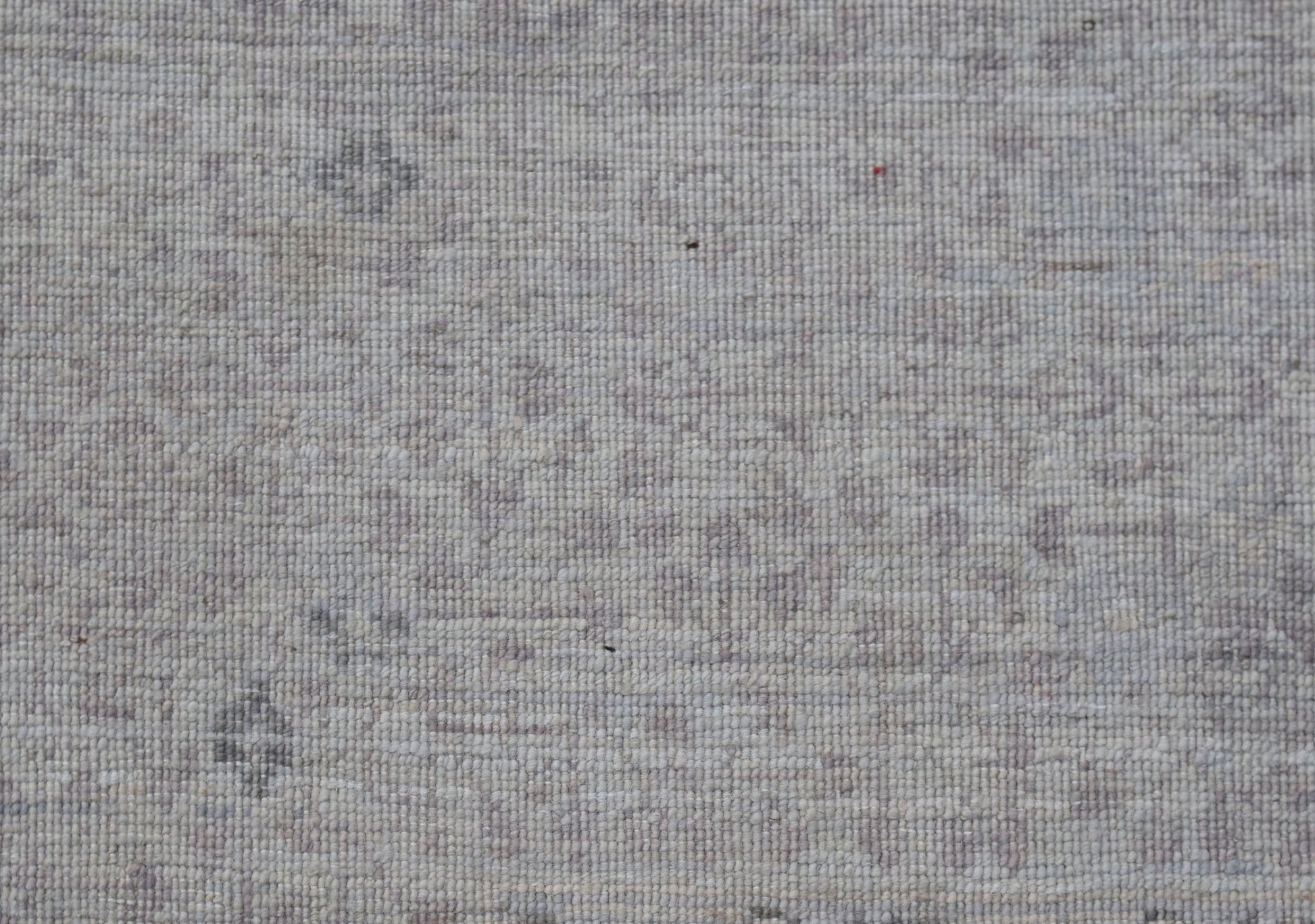 A close-up of a handwoven Afghan Balkh rug featuring a subtle, light-toned Mamluk pattern.