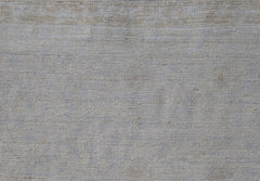 A close-up view of a handwoven Afghan Balkh rug featuring a neutral, textured wool weave.