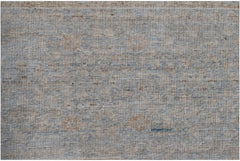 A handwoven Afghan Balkh rug featuring a textured, neutral pattern in shades of blue and beige.