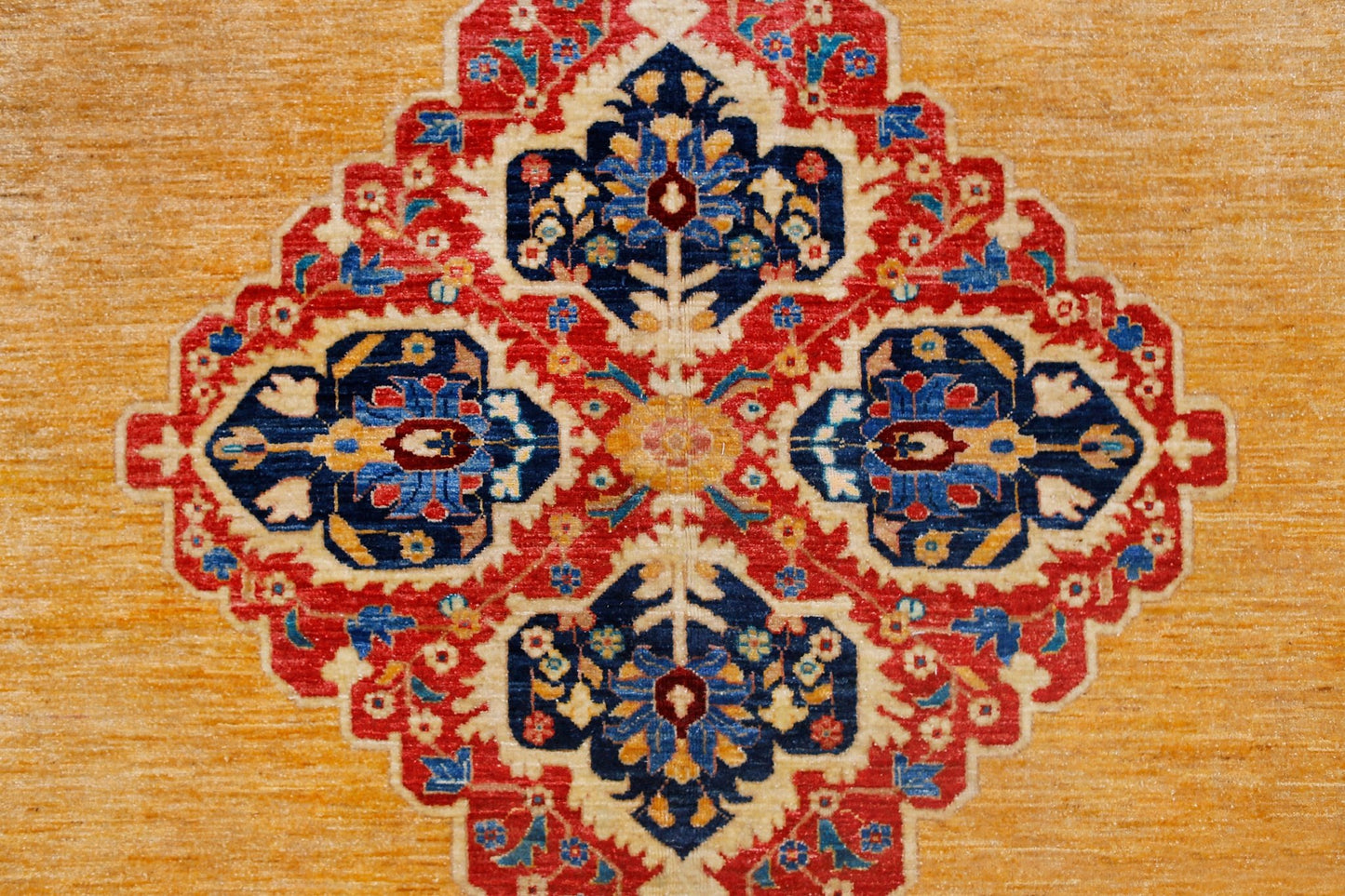 A handwoven Afghan Balkh rug featuring a central floral medallion on a golden yellow background.