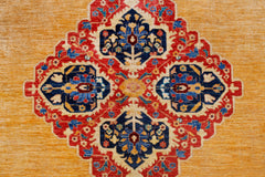 A handwoven Afghan Balkh rug featuring a central floral medallion on a golden yellow background.