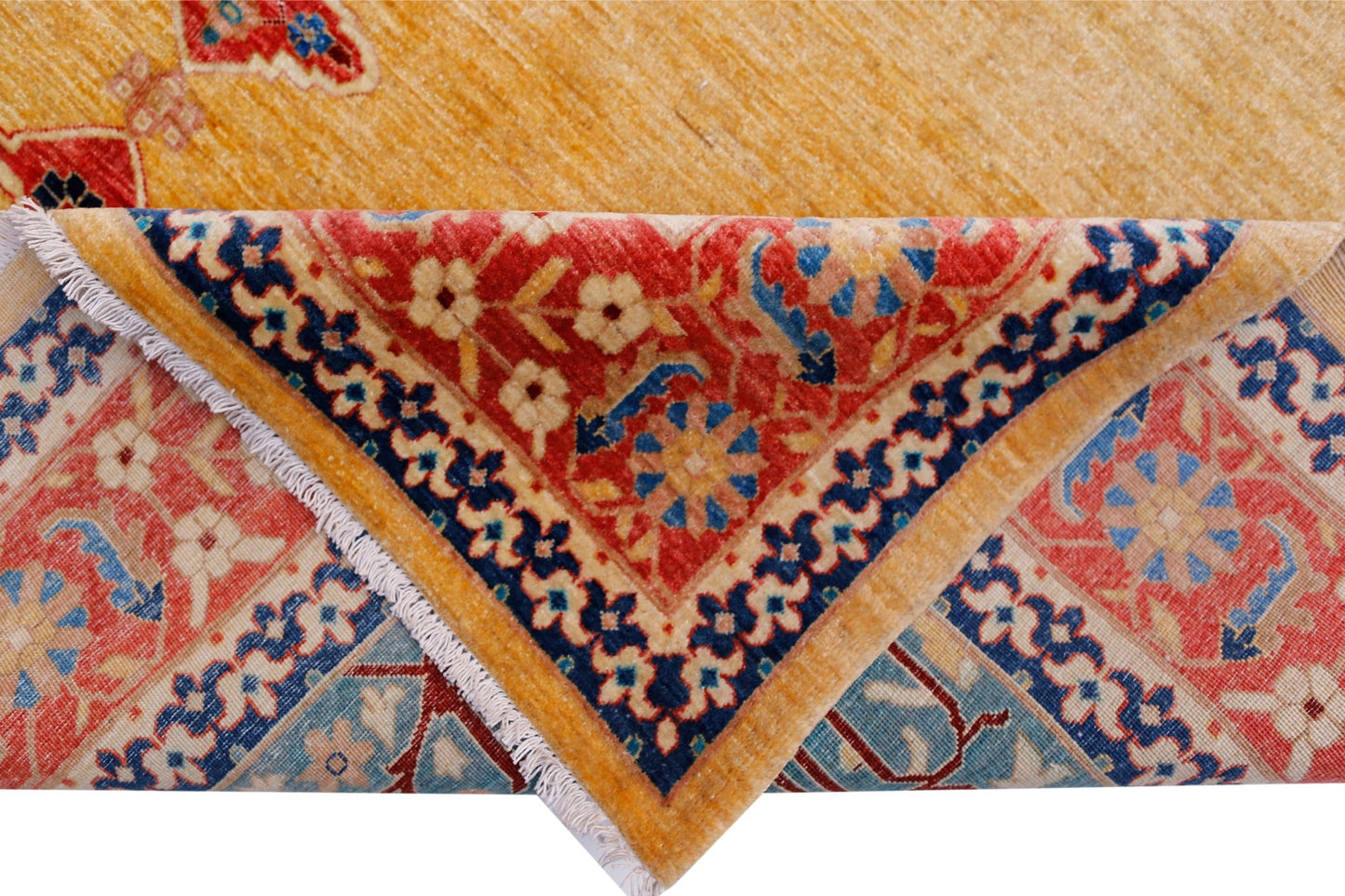 A handwoven Afghan Balkh rug featuring a golden yellow field and a folded corner with floral motifs.