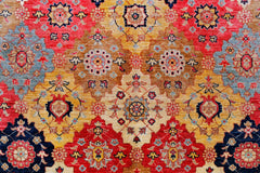 Handwoven Afghan Balkh rug featuring a geometric floral pattern in red, gold, and blue tones.