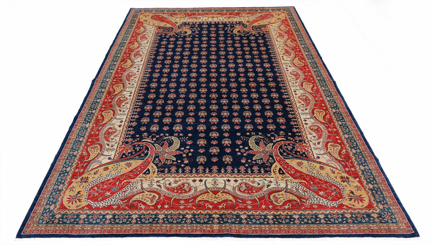 Handwoven Afghan Balkh rug featuring a dark blue field with floral motifs and red paisley borders.
