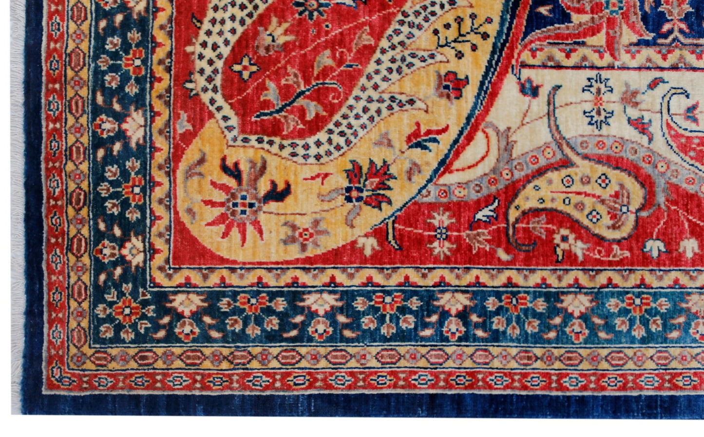 A handwoven Afghan Balkh rug featuring a traditional paisley pattern in red, yellow, and blue.