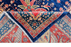 A handwoven Afghan Balkh rug featuring a traditional floral pattern in blue, red, and cream tones.