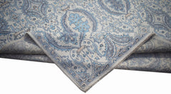 A handwoven Afghan Balkh rug featuring a traditional blue and cream floral pattern.