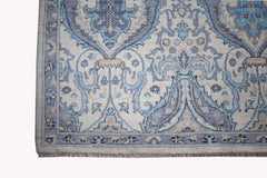 A handwoven Afghan Balkh rug featuring a traditional blue and beige floral pattern.
