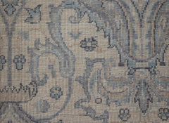 A handwoven Afghan Balkh rug featuring intricate blue and beige floral patterns on wool.