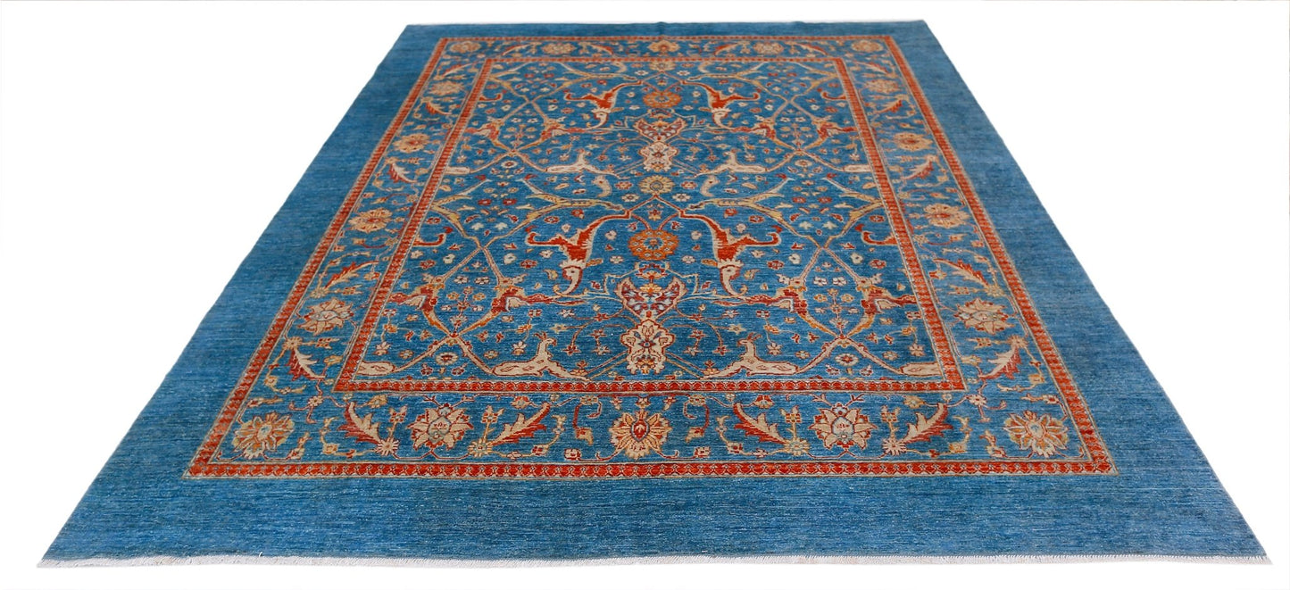 Handwoven Afghan Balkh rug featuring a traditional floral pattern in blue, red, and cream tones.