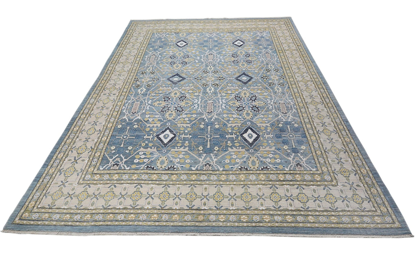 An Afghan Balkh rug featuring a blue field with intricate floral patterns and geometric motifs.