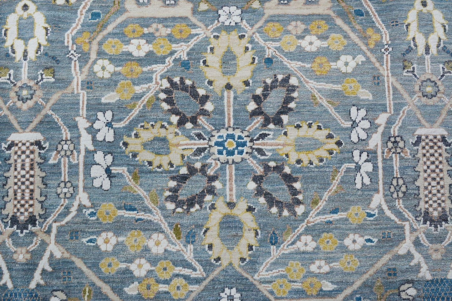 Handmade Afghan Balkh rug featuring a traditional floral medallion pattern in blue and yellow tones.