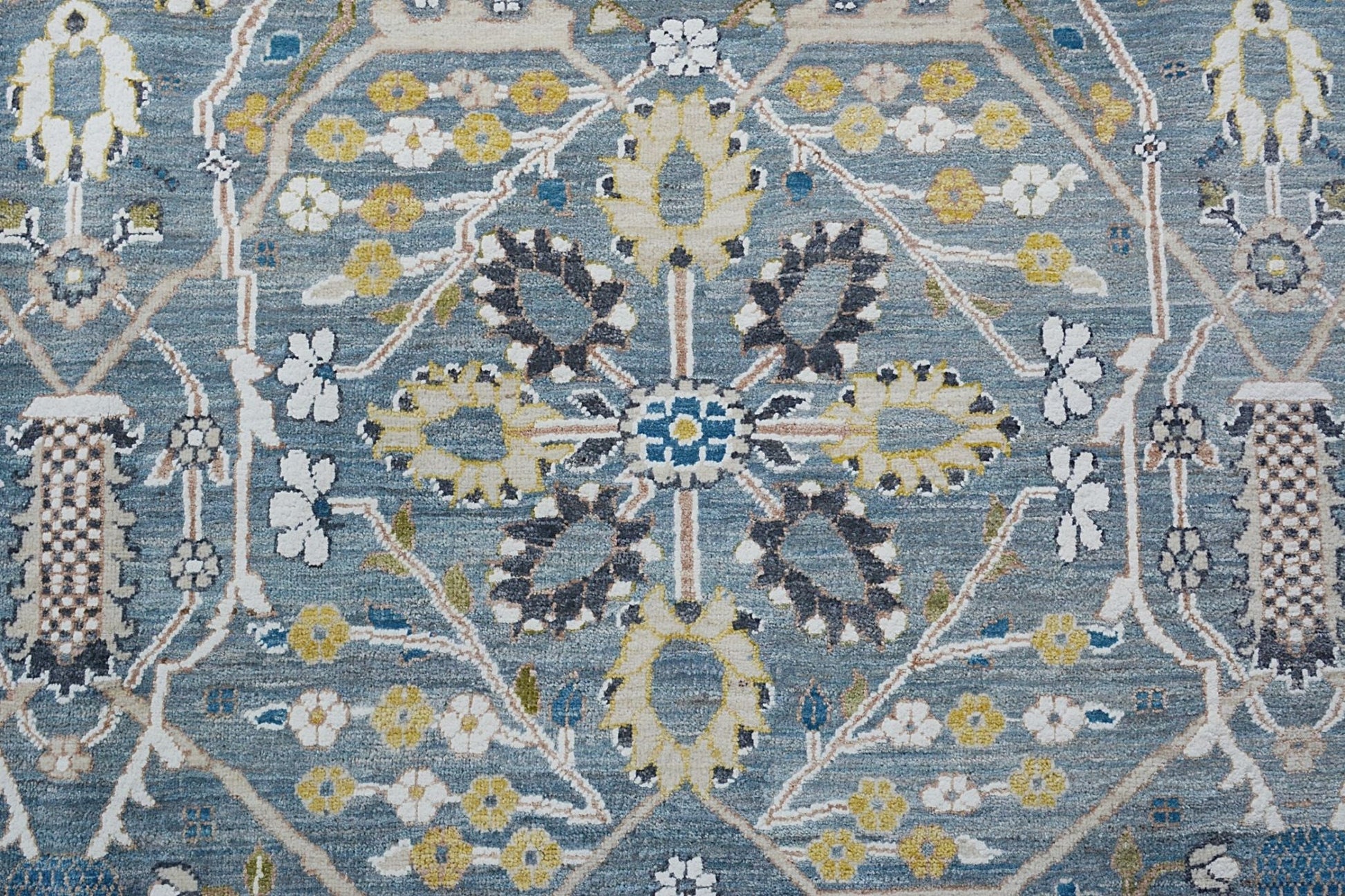 Handmade Afghan Balkh rug featuring a traditional floral medallion pattern in blue and yellow tones.