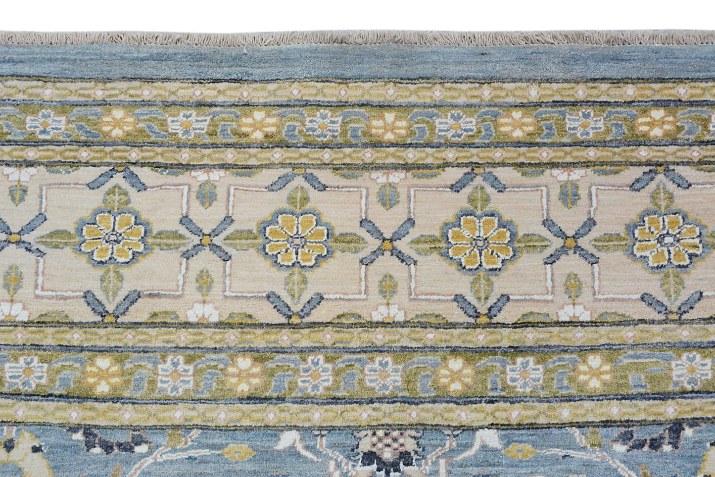 An Afghan Balkh rug featuring a floral border pattern in shades of blue, yellow, and beige.