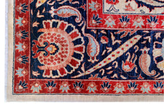 A handwoven Afghan Balkh rug featuring a traditional floral pattern in red, blue, and cream tones.