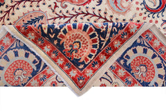 A handwoven Afghan Balkh rug featuring a traditional floral pattern in red, blue, and cream.