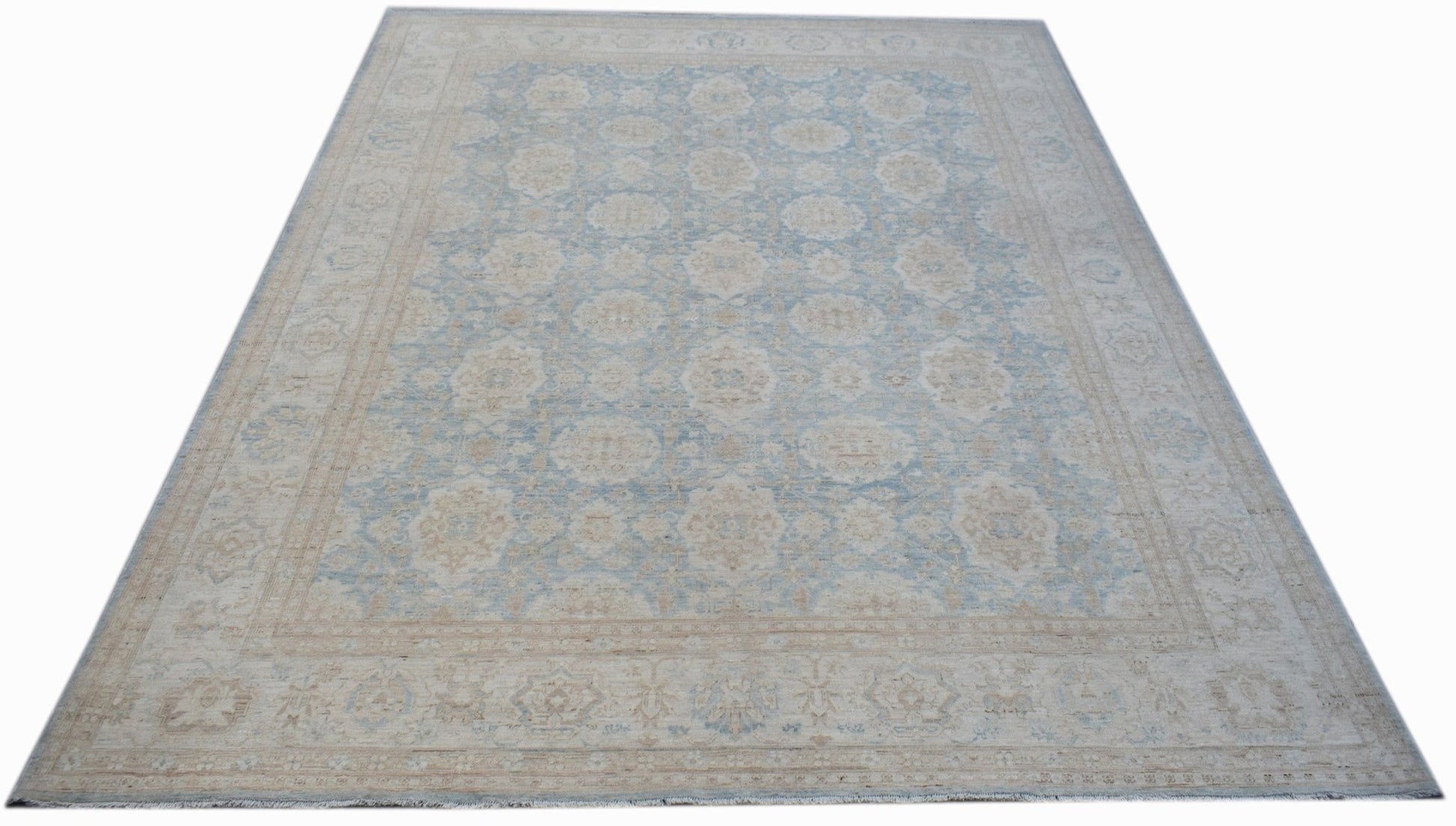 A handmade Afghan Balkh rug featuring a traditional floral pattern in soft blue and beige tones.