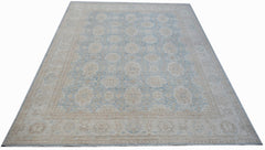 A handmade Afghan Balkh rug featuring a traditional floral pattern in soft blue and beige tones.