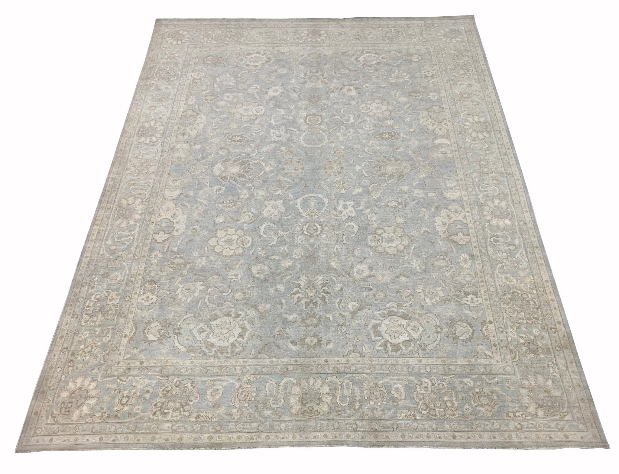 A handmade Afghan Balkh rug featuring a traditional floral pattern in soft blue and beige tones.