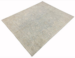 A handmade Afghan Balkh rug featuring a traditional floral pattern in soft blue and beige tones.
