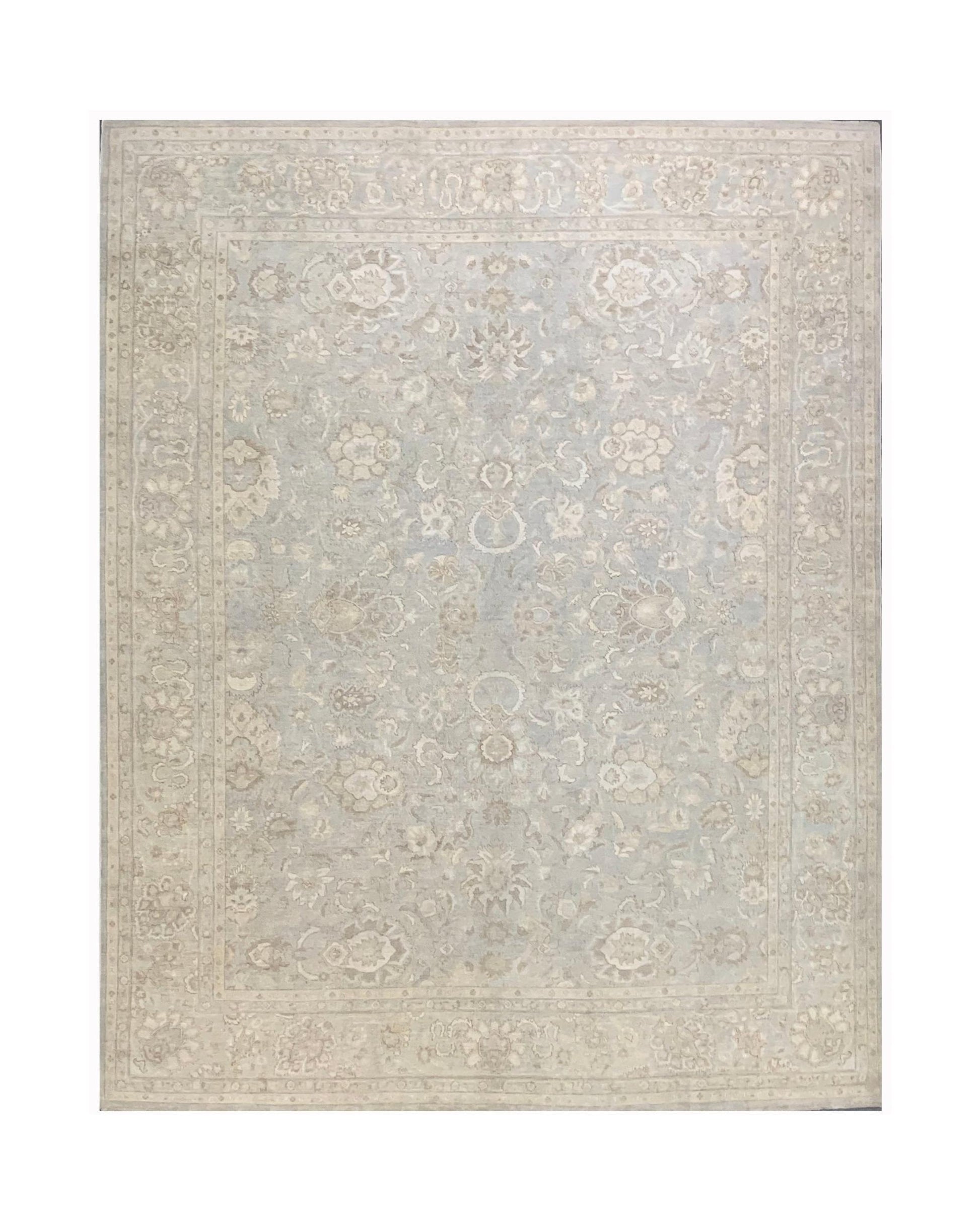 A handmade Afghan Balkh rug featuring a traditional floral pattern in soft blue and beige tones.