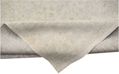 A handwoven Afghan Balkh rug in neutral beige tones with a subtle traditional pattern.