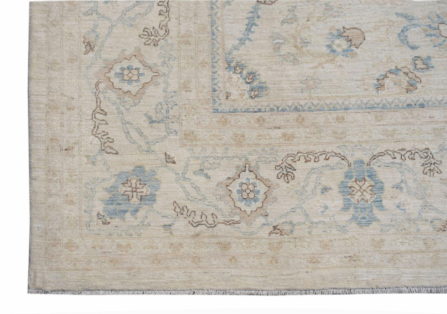 A handwoven Afghan Balkh rug featuring a traditional floral pattern in soft blue and beige tones.
