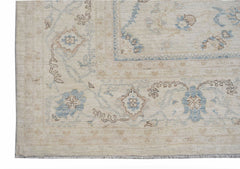 A handwoven Afghan Balkh rug featuring a traditional floral pattern in soft blue and beige tones.