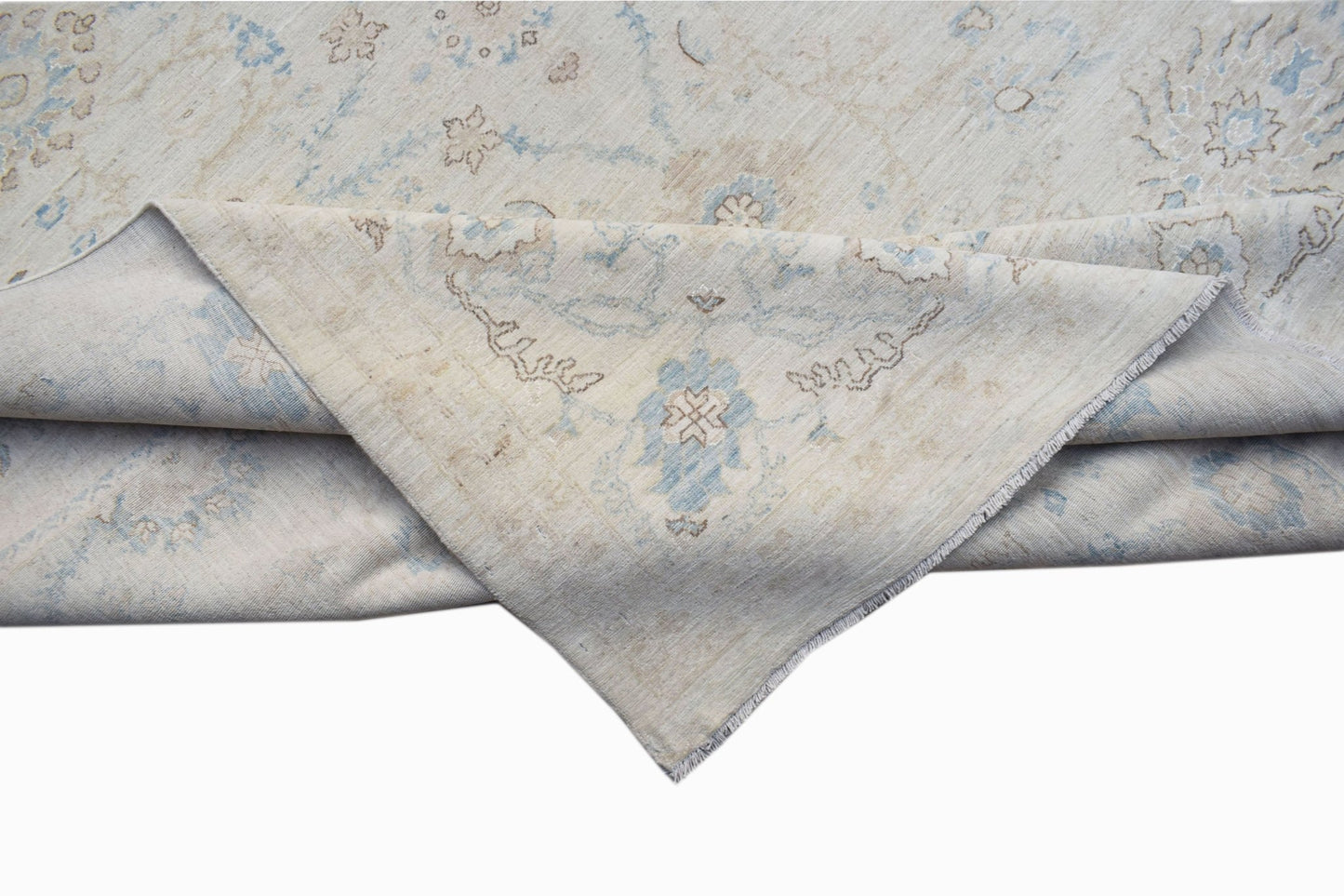 An Afghan Balkh rug featuring a traditional floral pattern in soft blue and beige tones.
