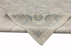An Afghan Balkh rug featuring a traditional floral pattern in soft blue and beige tones.