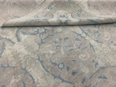 A handmade Afghan Balkh rug featuring a traditional floral pattern in soft blue and beige tones.