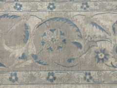 A handmade Afghan Balkh rug featuring a traditional floral pattern in muted blue and beige tones.