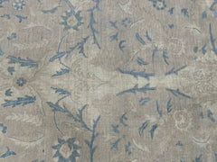 A handmade Afghan Balkh rug featuring a traditional floral pattern in muted blue and beige tones.