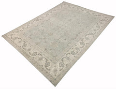An Afghan Balkh rug featuring a traditional floral pattern in soft grey and beige tones.