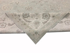 A handmade Afghan Balkh rug featuring a light grey field with traditional floral motifs.