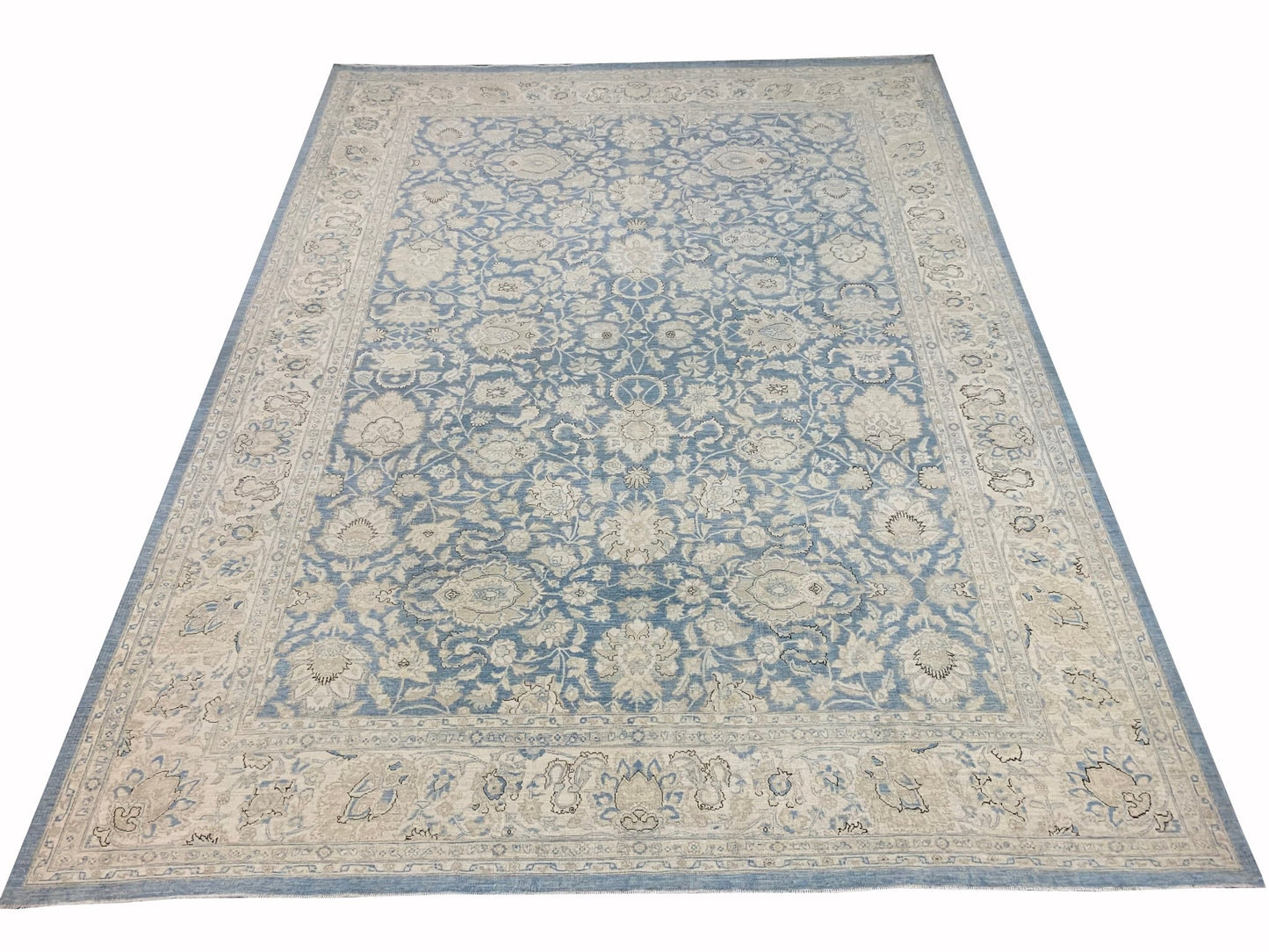 An Afghan Balkh rug featuring a traditional floral pattern in shades of blue and cream.