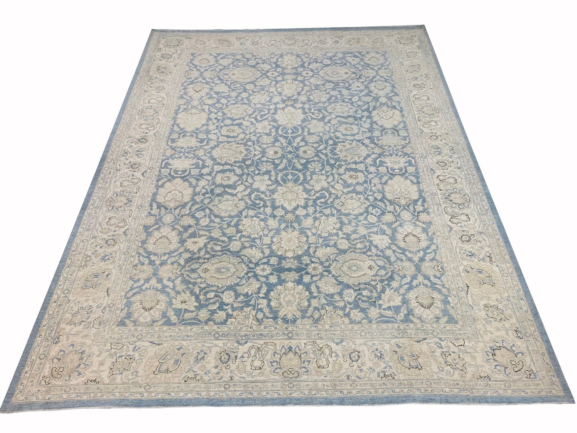 An Afghan Balkh rug featuring a traditional floral pattern in shades of blue and cream.