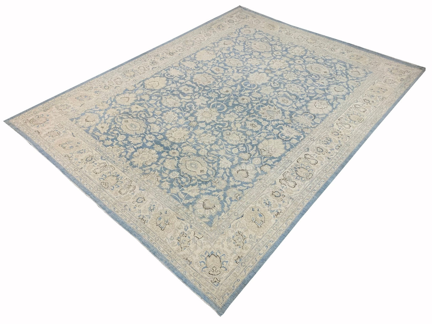 A handmade Afghan Balkh rug featuring a traditional floral pattern in shades of blue and cream.