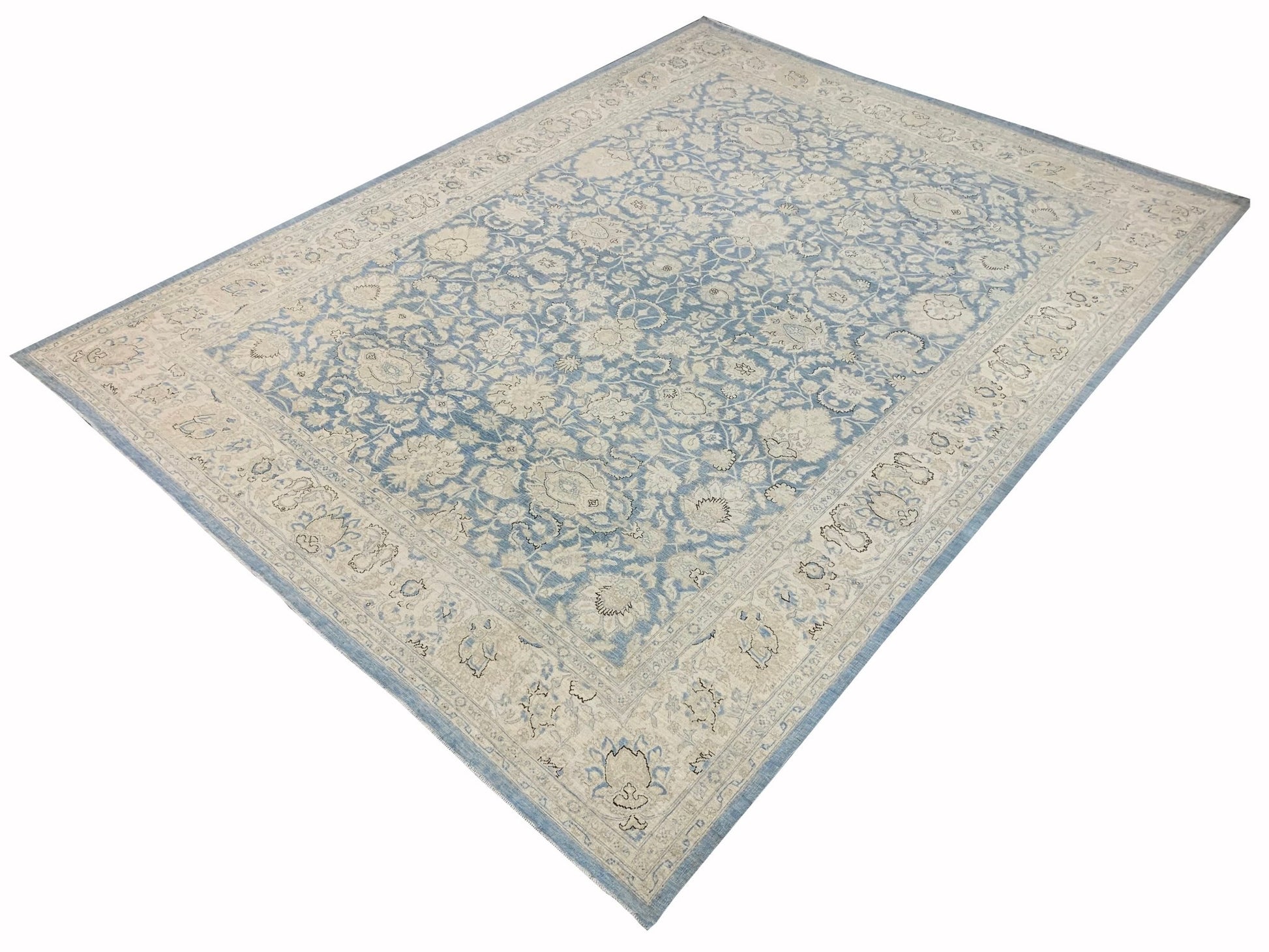 A handmade Afghan Balkh rug featuring a traditional floral pattern in shades of blue and cream.