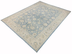 A handmade Afghan Balkh rug featuring a traditional floral pattern in shades of blue and cream.
