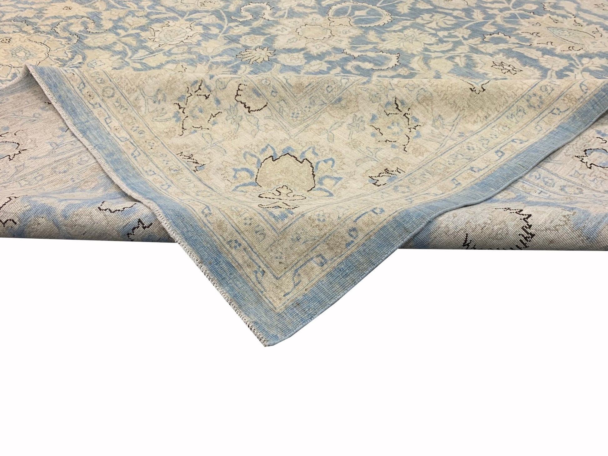 A handmade Afghan Balkh rug featuring a traditional floral pattern in shades of blue and cream.
