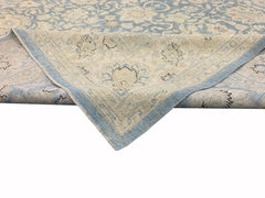 A handmade Afghan Balkh rug featuring a traditional floral pattern in shades of blue and cream.