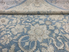 A handmade Afghan Balkh rug featuring a traditional floral pattern in shades of blue and cream.