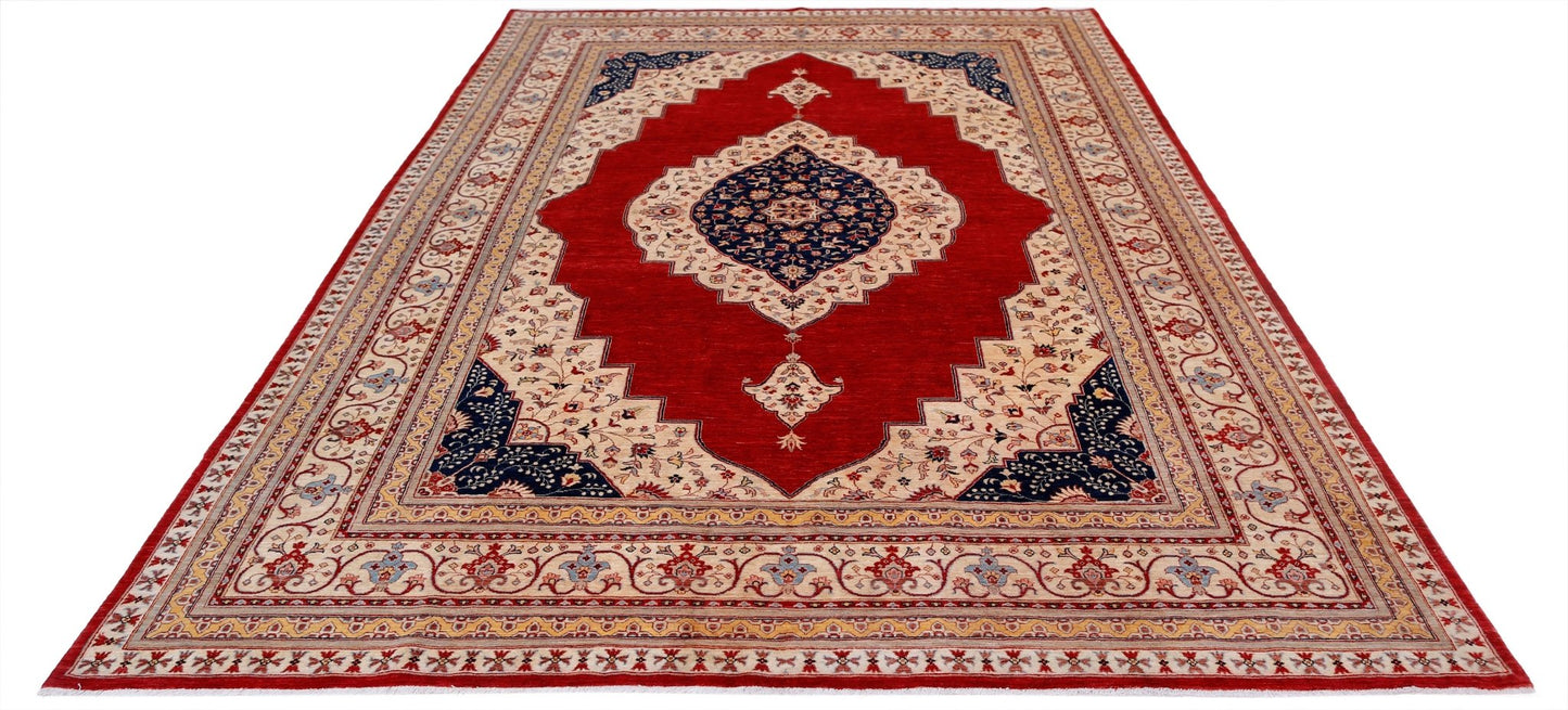 Handwoven Afghan Balkh rug featuring a central navy medallion on a red field with floral borders.